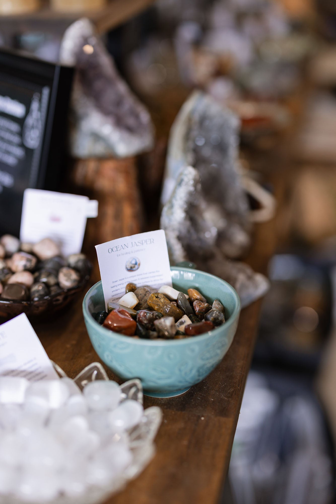 Bowl on a shelf filled with crystal chips and tumbled stones