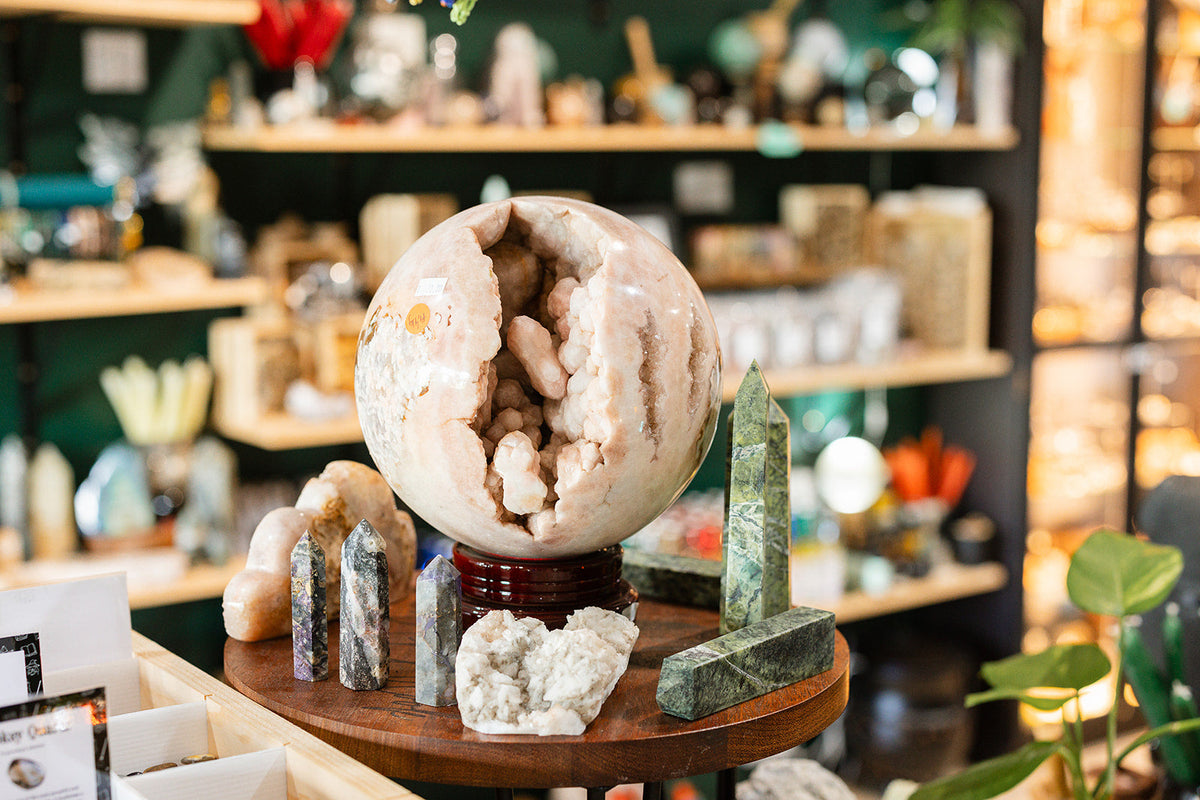 Inside The Witchy Nook store filled with tables and bookshelves overflowing with crystals and apothecary items