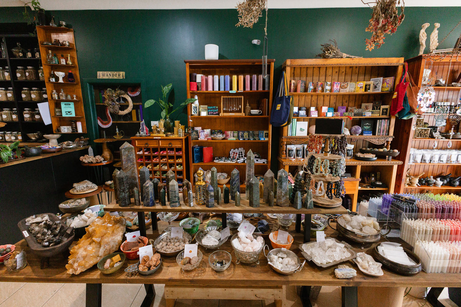 Inside The Witchy Nook store filled with tables and bookshelves overflowing with crystals and apothecary items