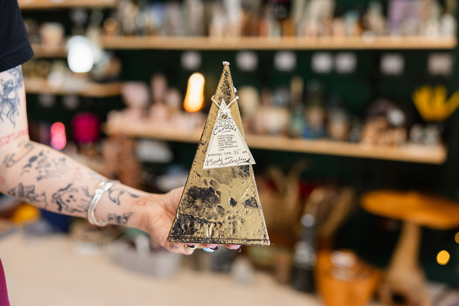 Candle Ancient Pyramid 35hr - Nimbin candle displayed with a blurred background.