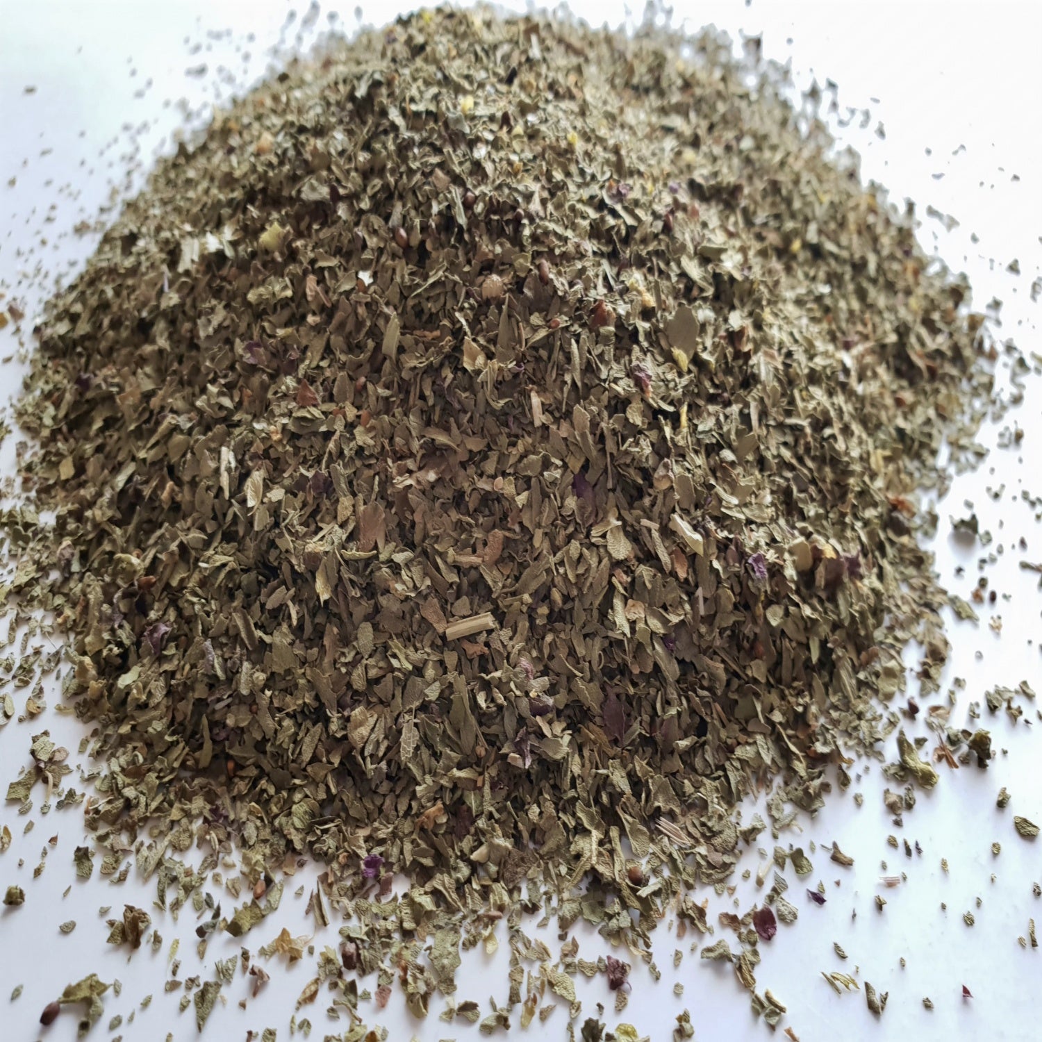 Basil herb on a white surface.