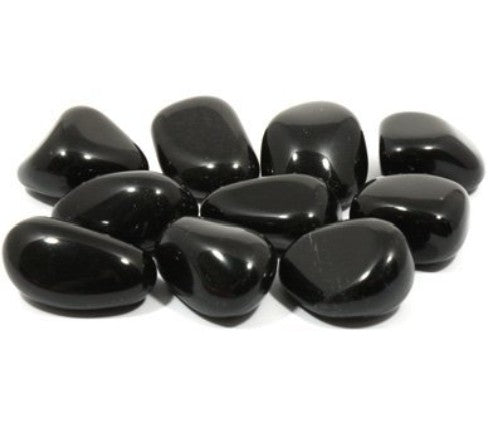 The image displays a collection of polished Black Obsidian tumbled stones on arranged on a white background