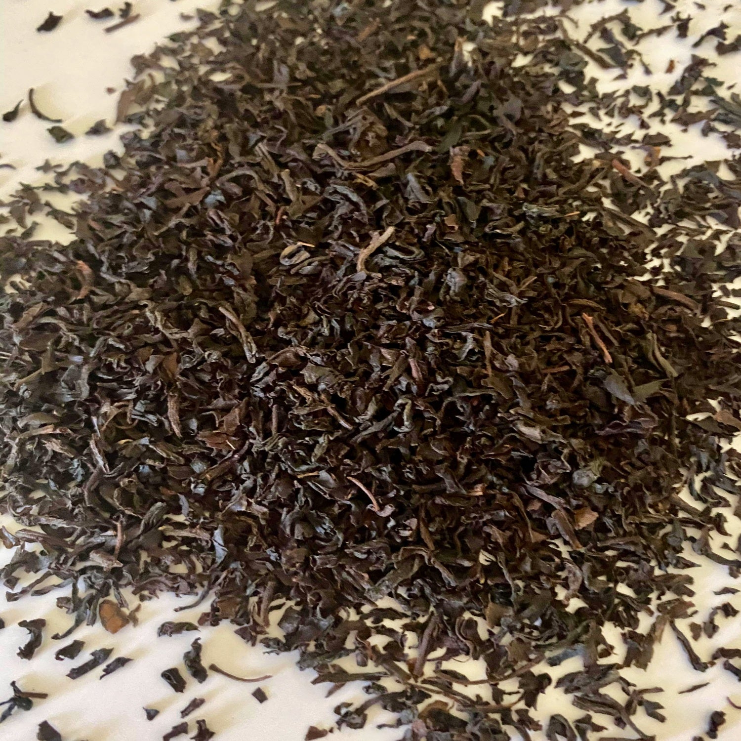 Black Tea Leaves herb on a white surface.