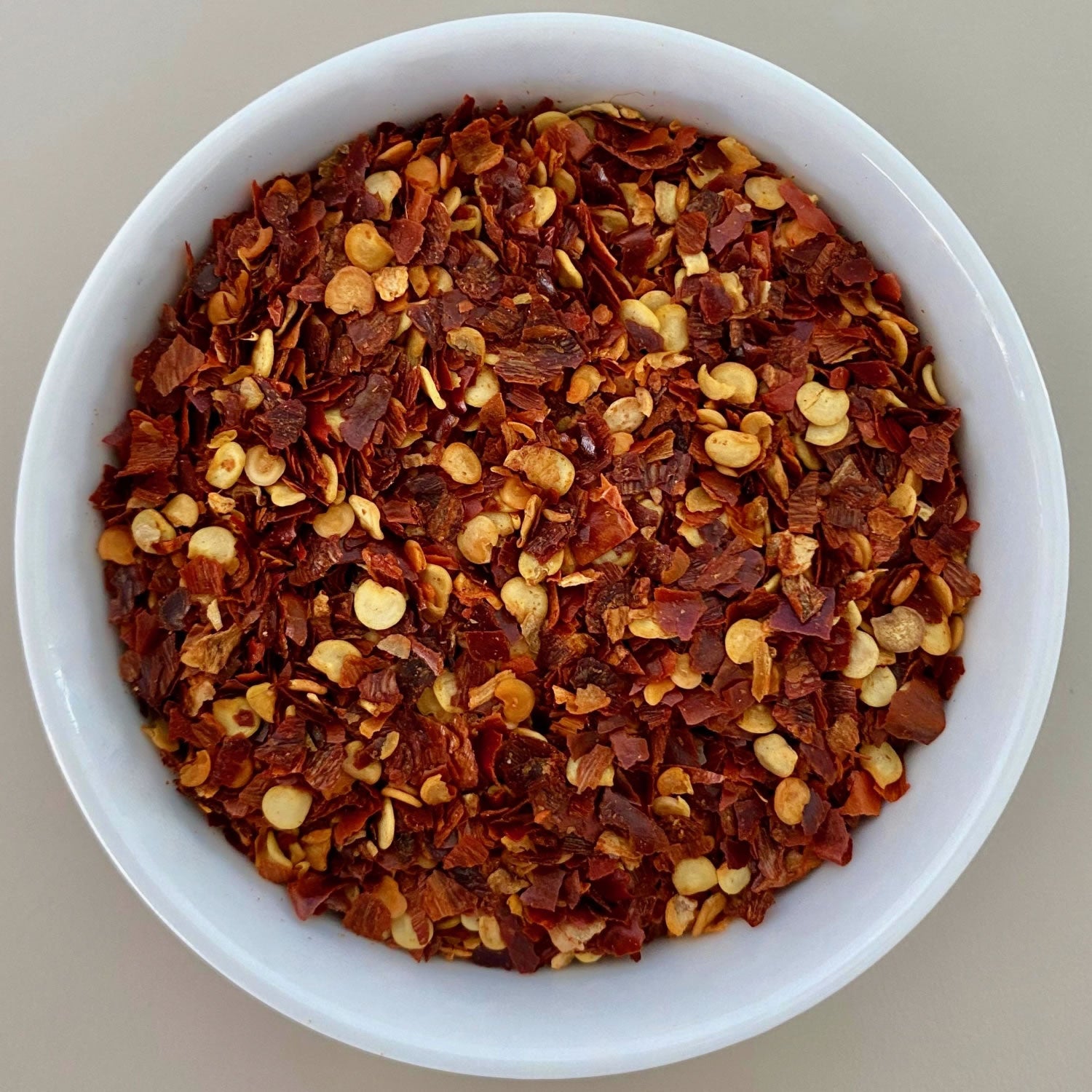 Chilli Flakes herb in a white bowl.