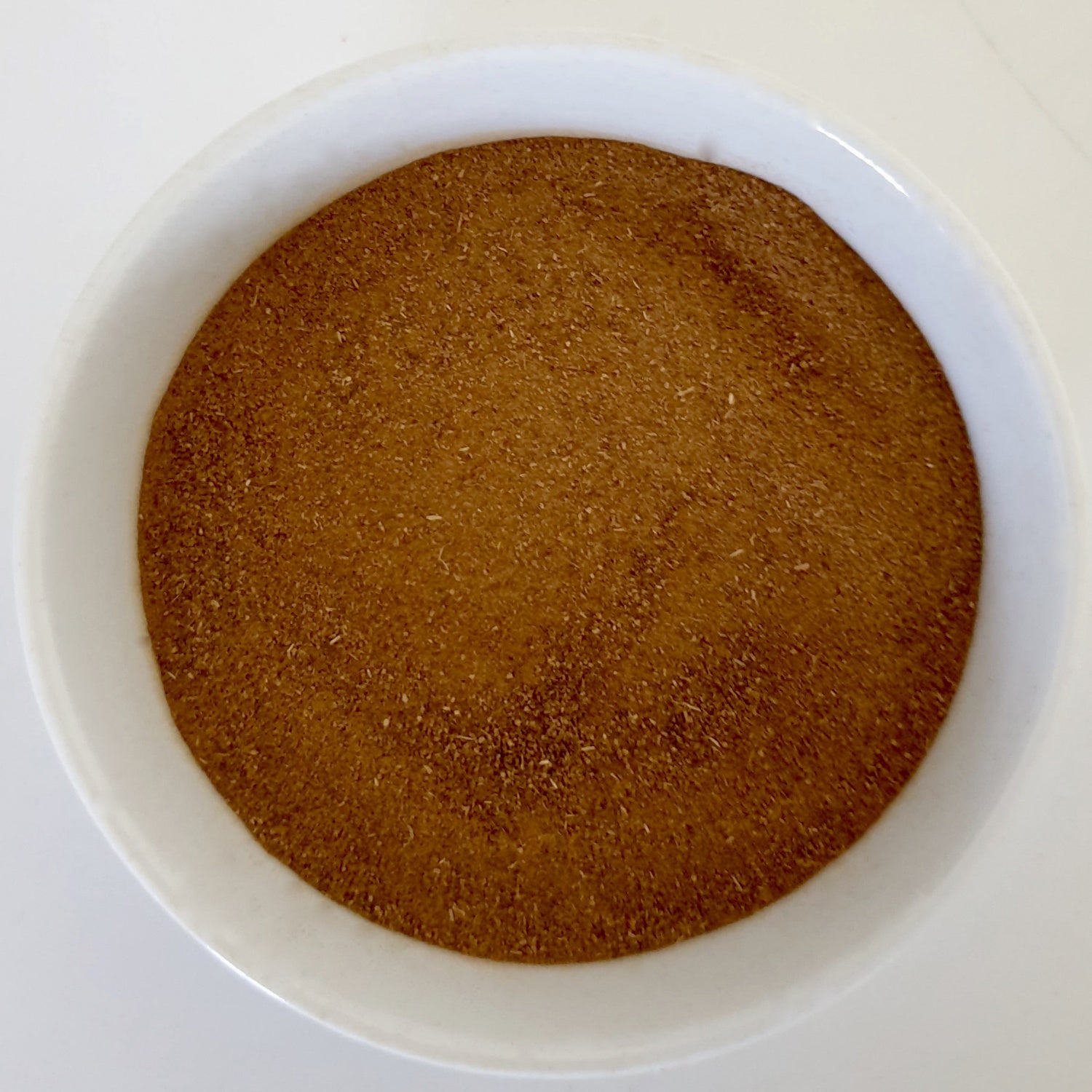 Cinnamon Powder herb n a white surface.