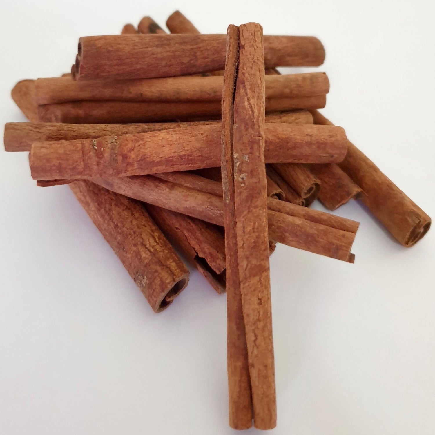 Cinnamon Stick herb on a white surface.