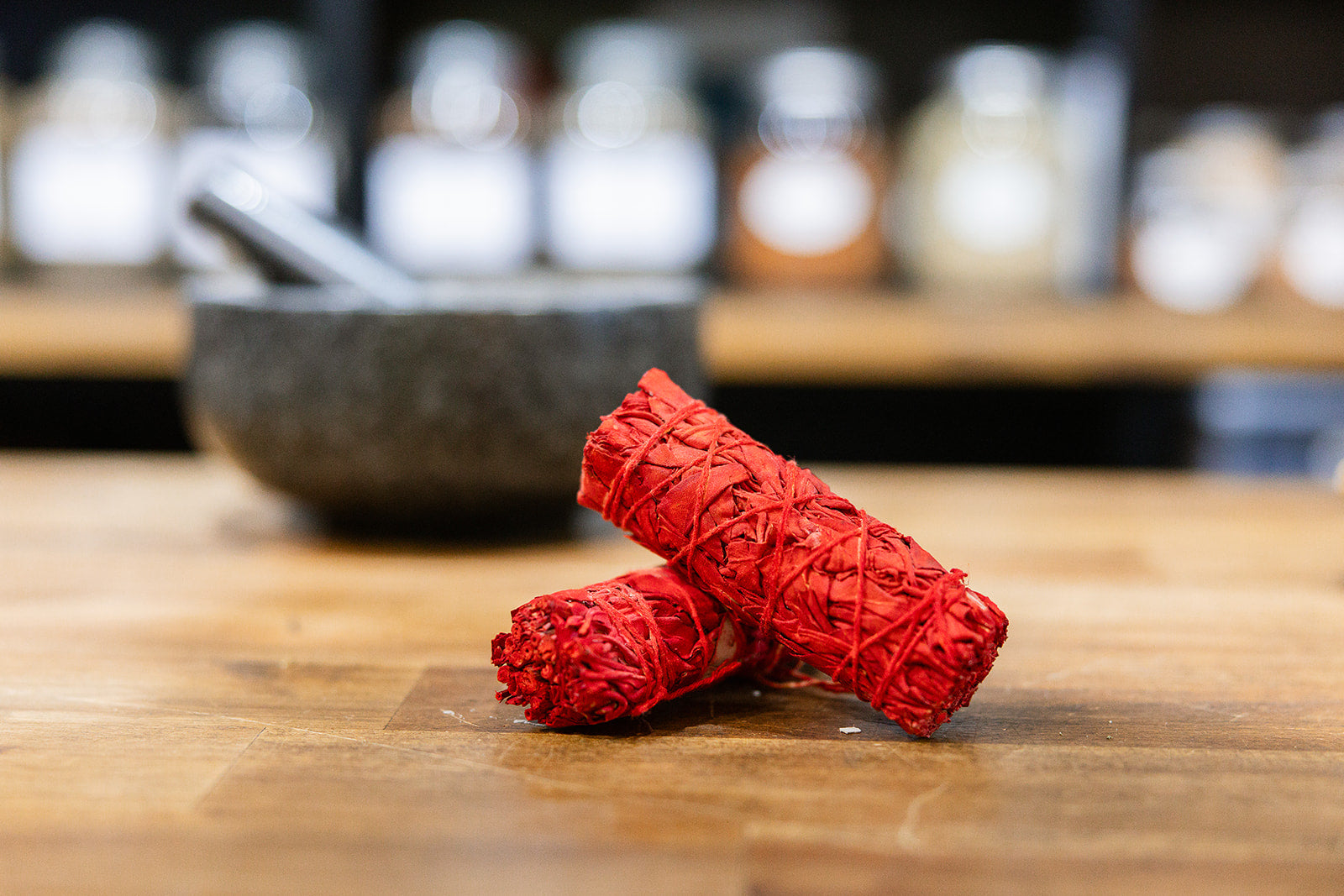 Dragons Blood Smudge Sticks on timber bench with mortar and pestle in background