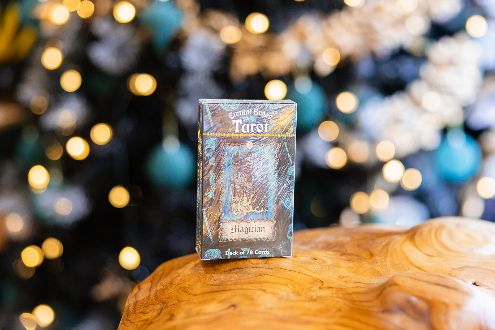 Tarot cards Eternal Bones Tarot Deck displayed on a wooden surface with a blurred background