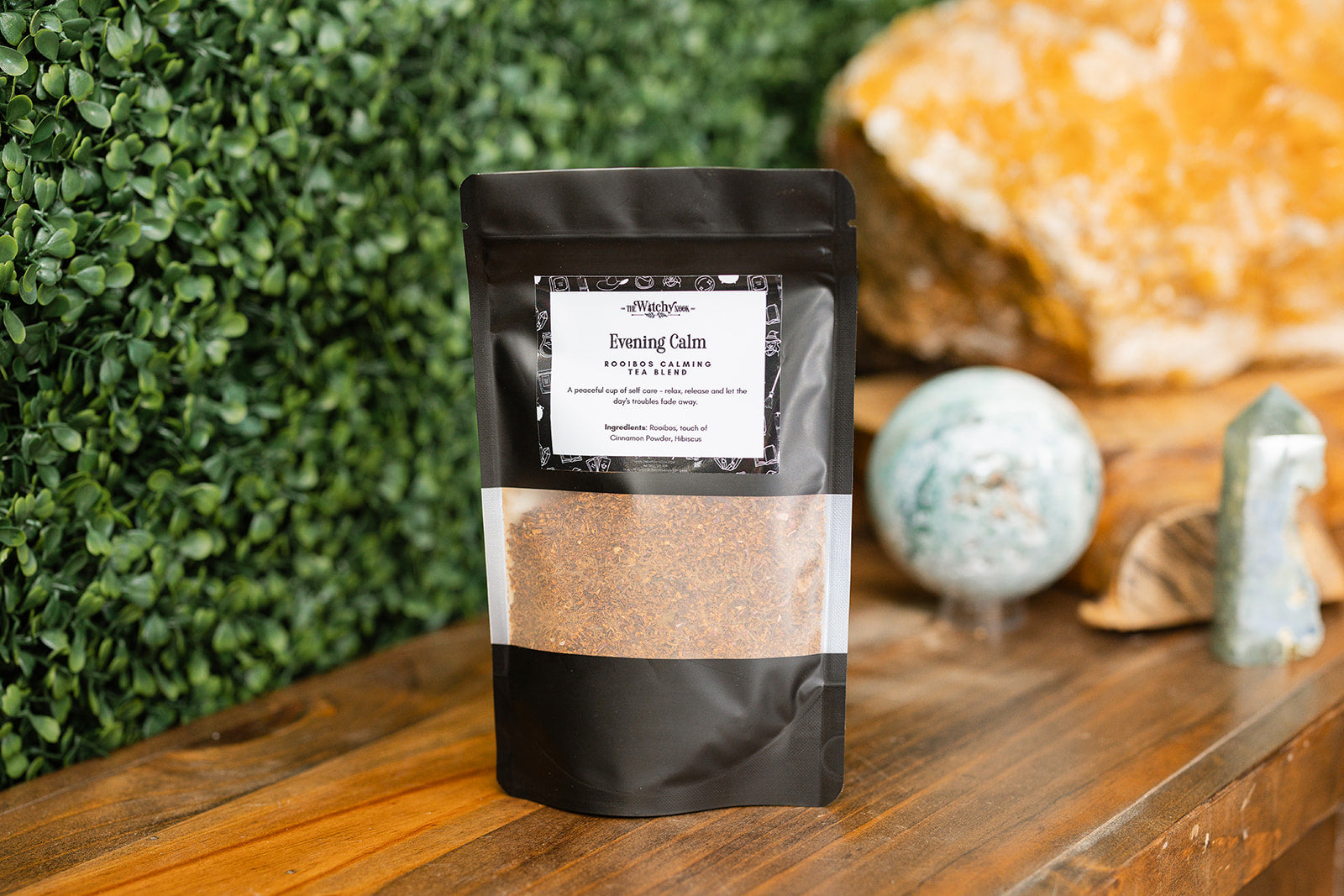 Evening Calm Tea Blend on a timber benchtop with crystals in the background