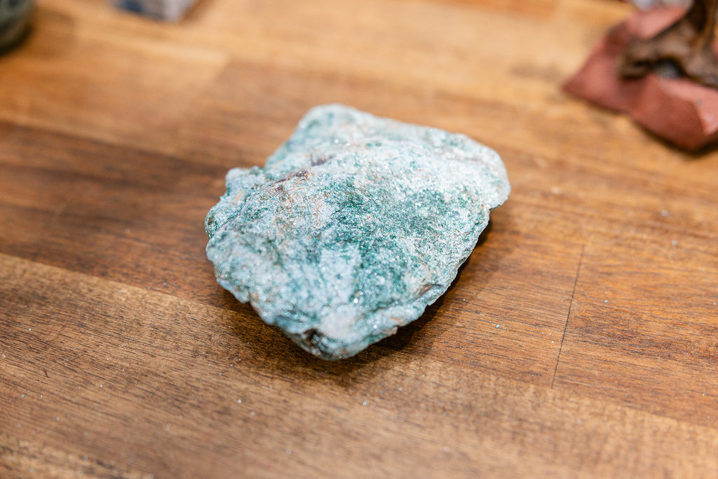 Natural crystal raw natural Fuchsite Raw on wooden background