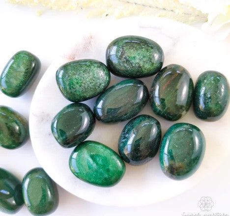 crystals Fuchsite Tumble on a plate and a white background