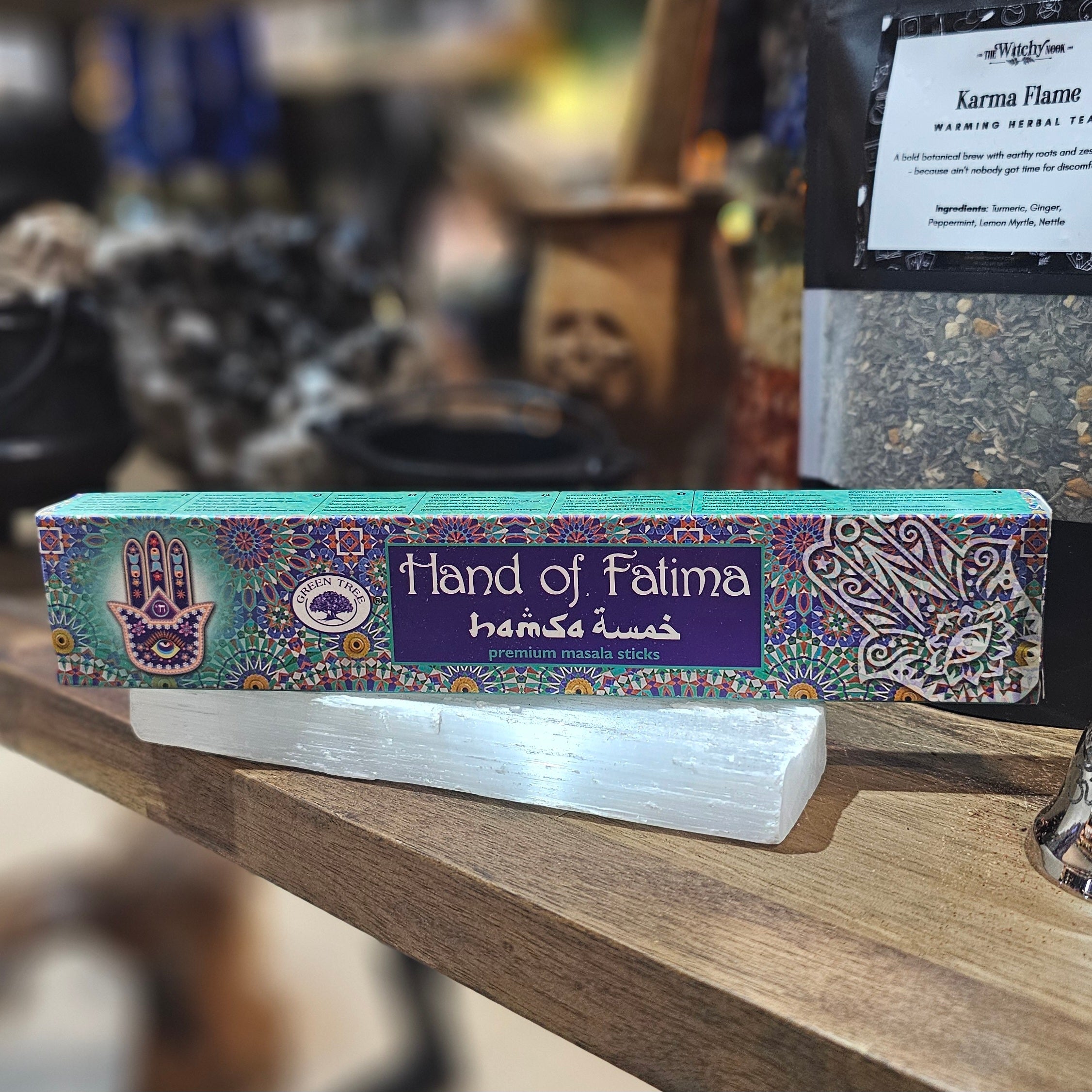 ‘Hand Of Fatima Incense’ Displayed on a wooden table surrounded by crystals and herbs. 