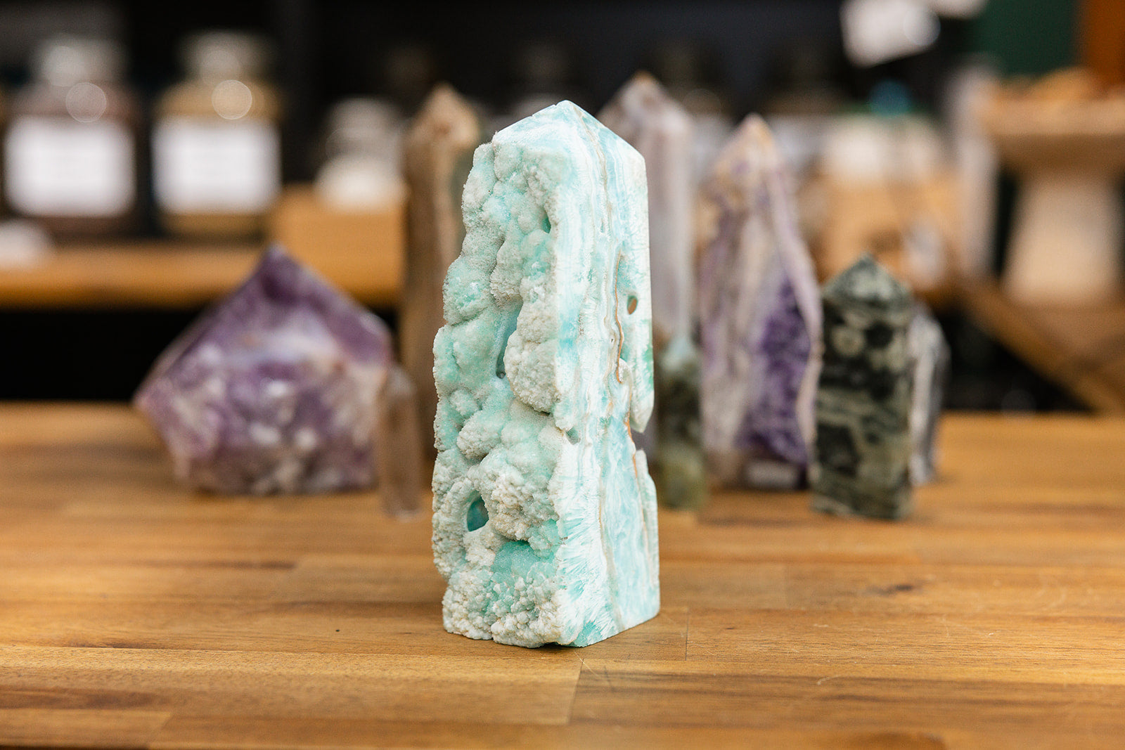 Natural Hemimorphite Tower with collection of colourful natural towers on wooden background