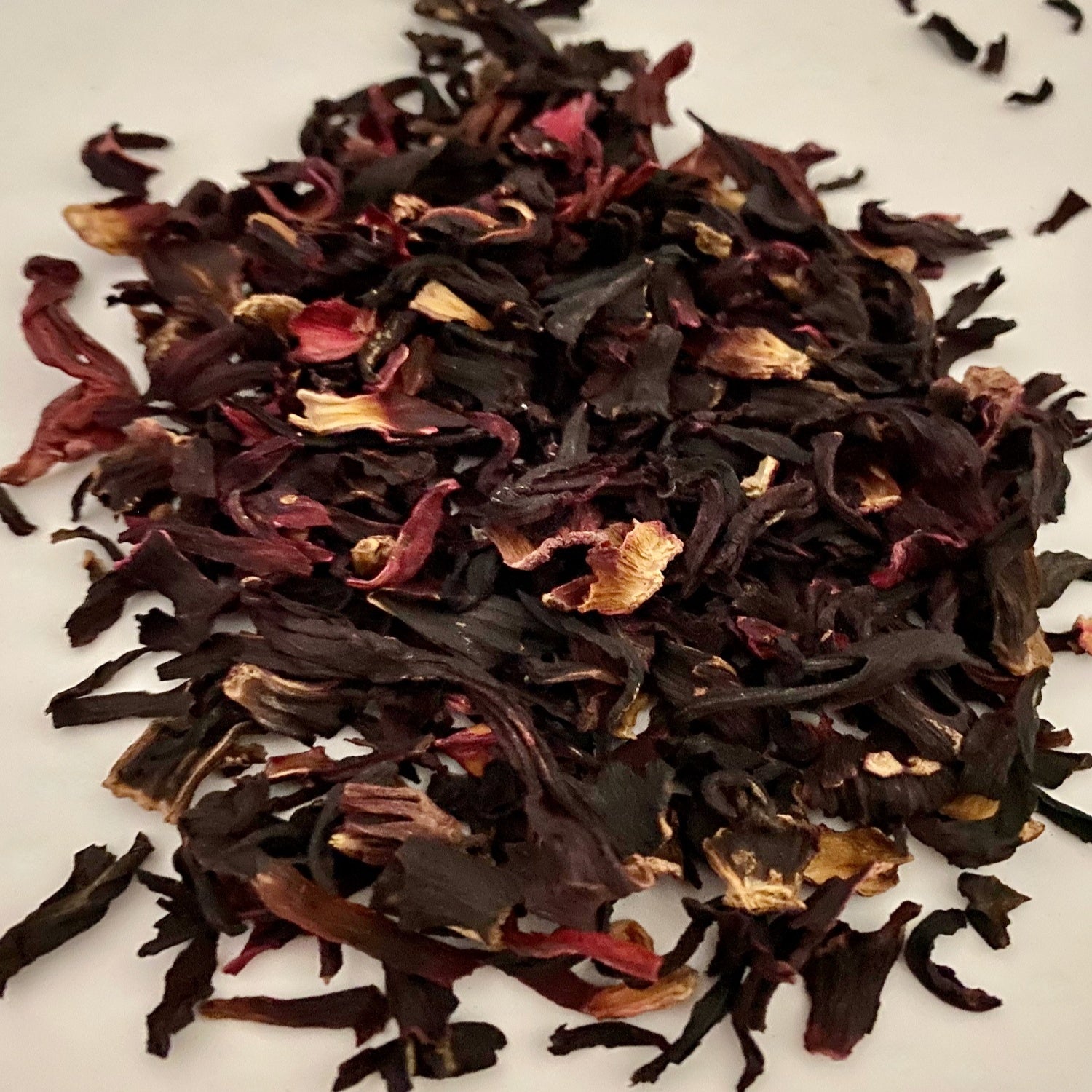 Hibiscus herb on a white surface.