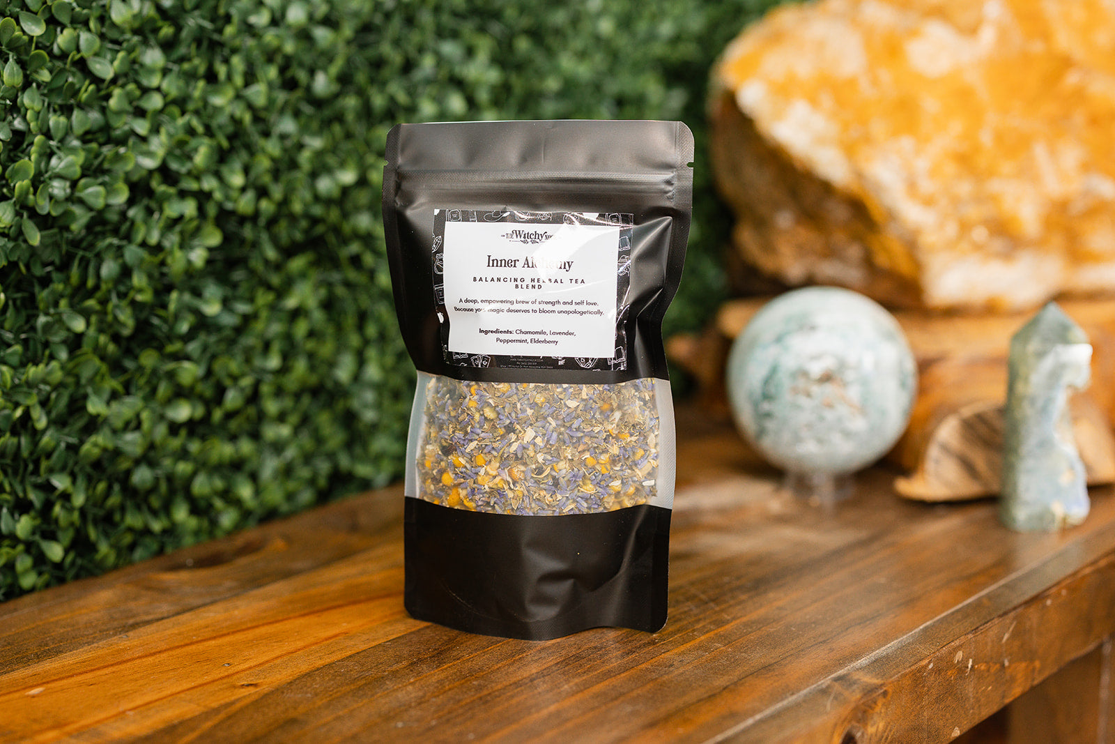Inner Alchemy Tea Blend on timber benchtop with crystals in background