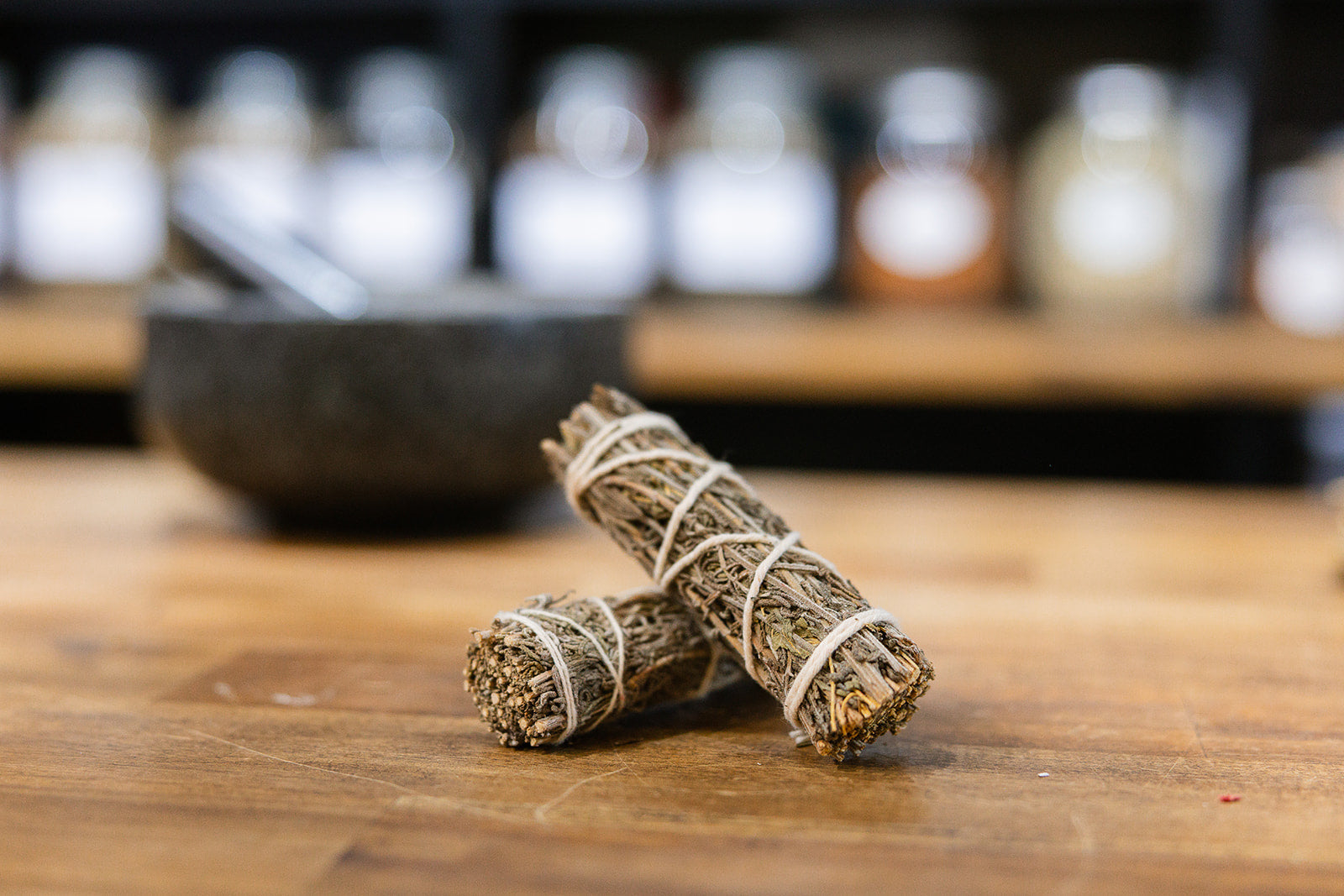 Lavender Smudge Stick on timber bench with mortar and pestle in background