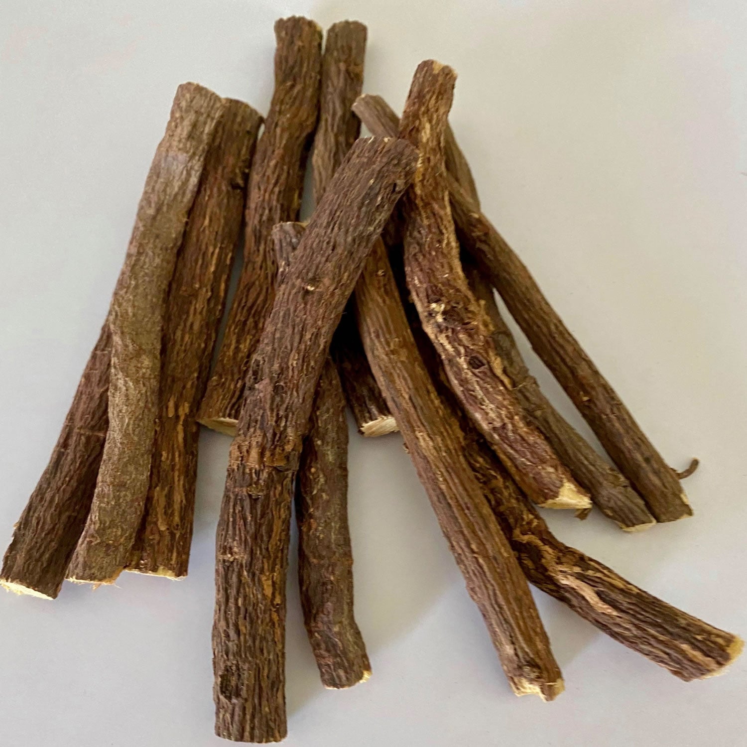 Licorice Sticks herb on a white surface.