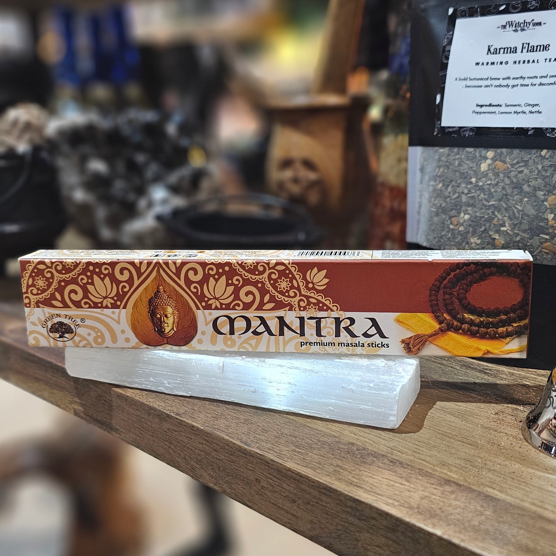 ‘Mantra Incense’ Displayed on a wooden table surrounded by crystals and herbs. 