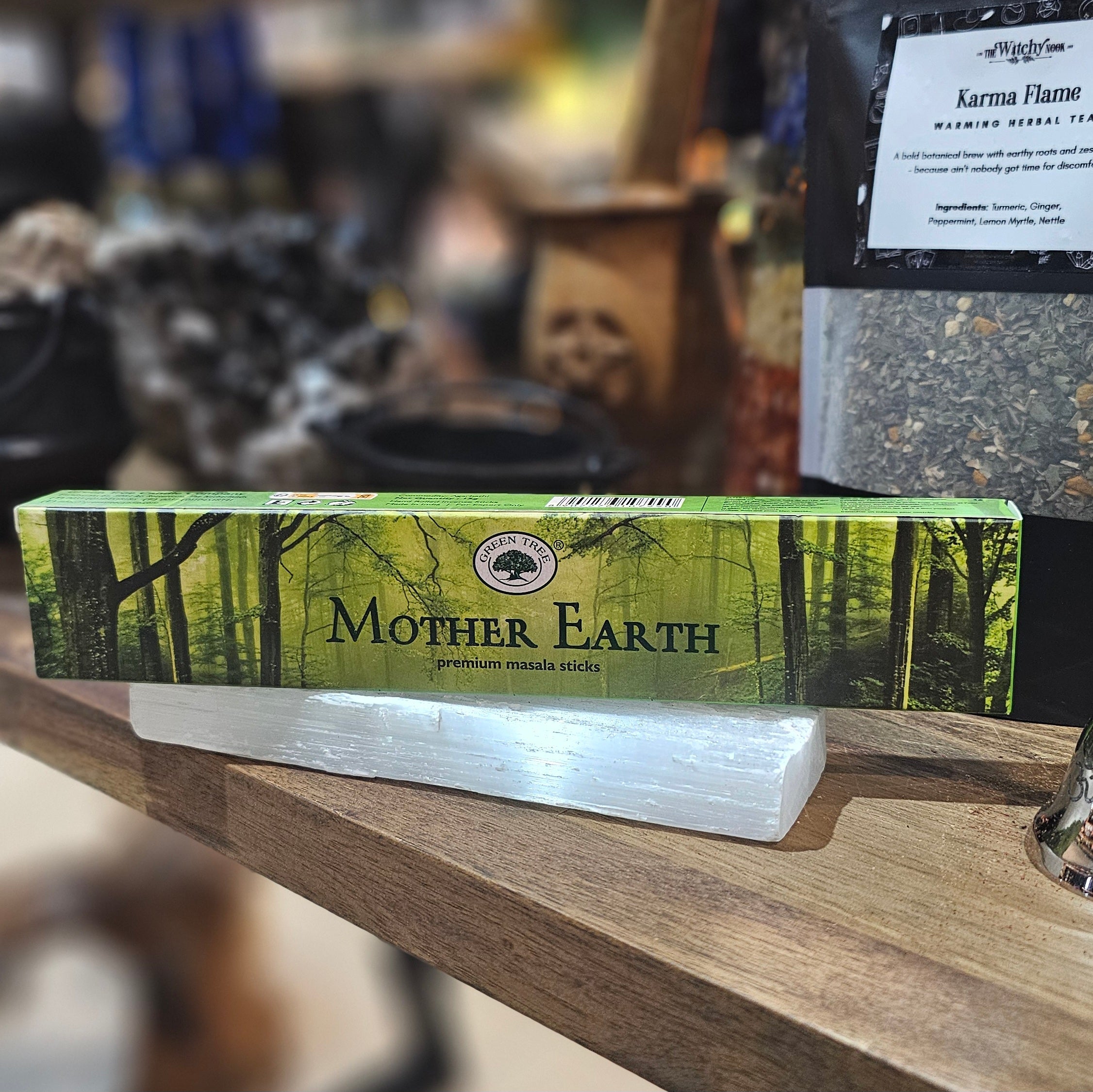 ‘Mother Earth Incense’ Displayed on a wooden table surrounded by crystals and herbs. 