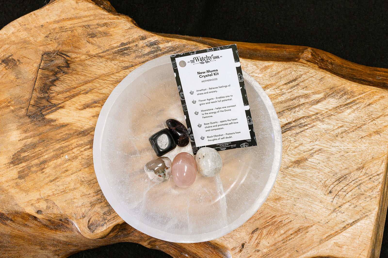 Packaged product labeled 'New Mums Tumble Kit' by 'Witchy Nook' on a wooden surface in the background with products displayed in a bowl.