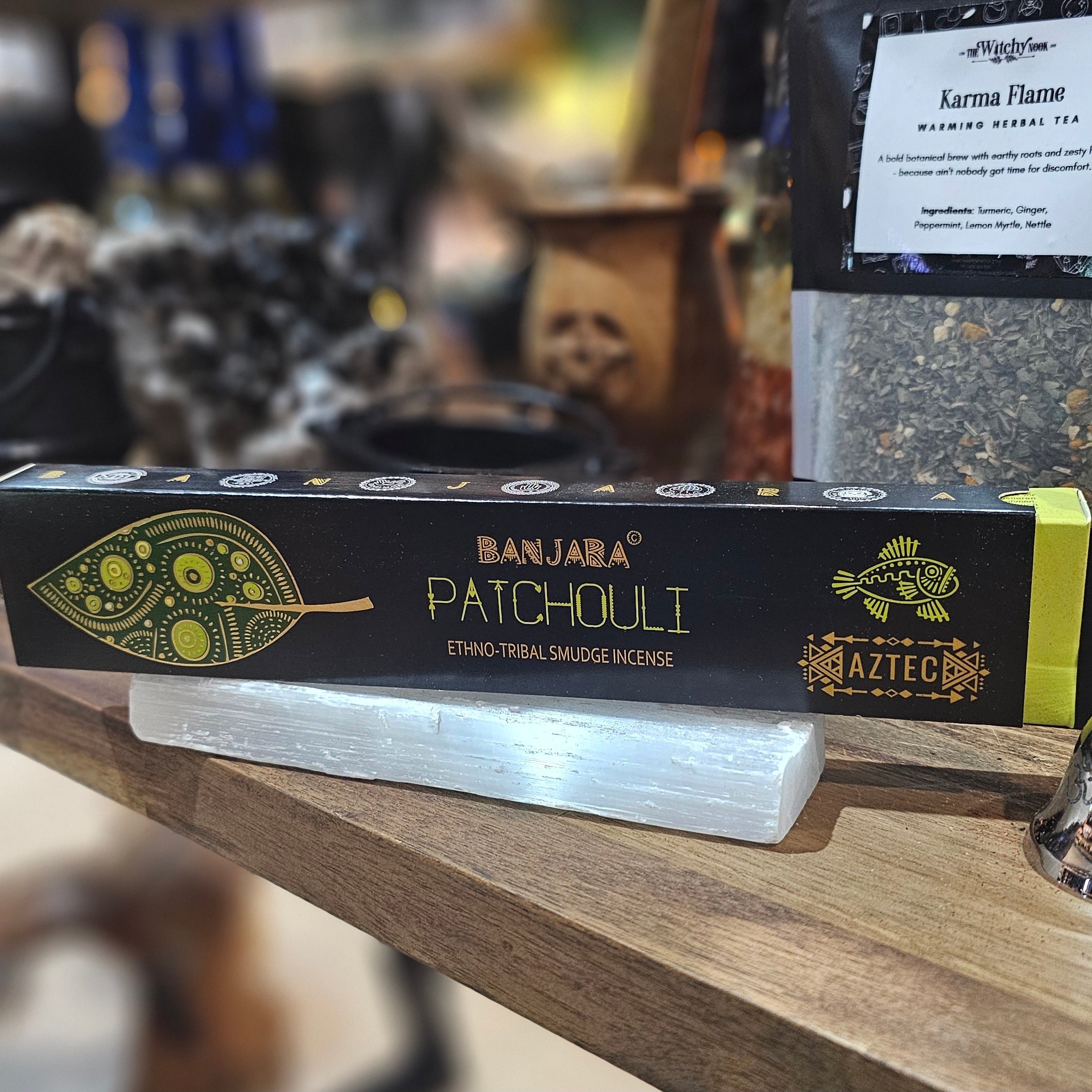 ‘Banjara Patchouli Incense’ Displayed on a wooden table surrounded by crystals and herbs. 