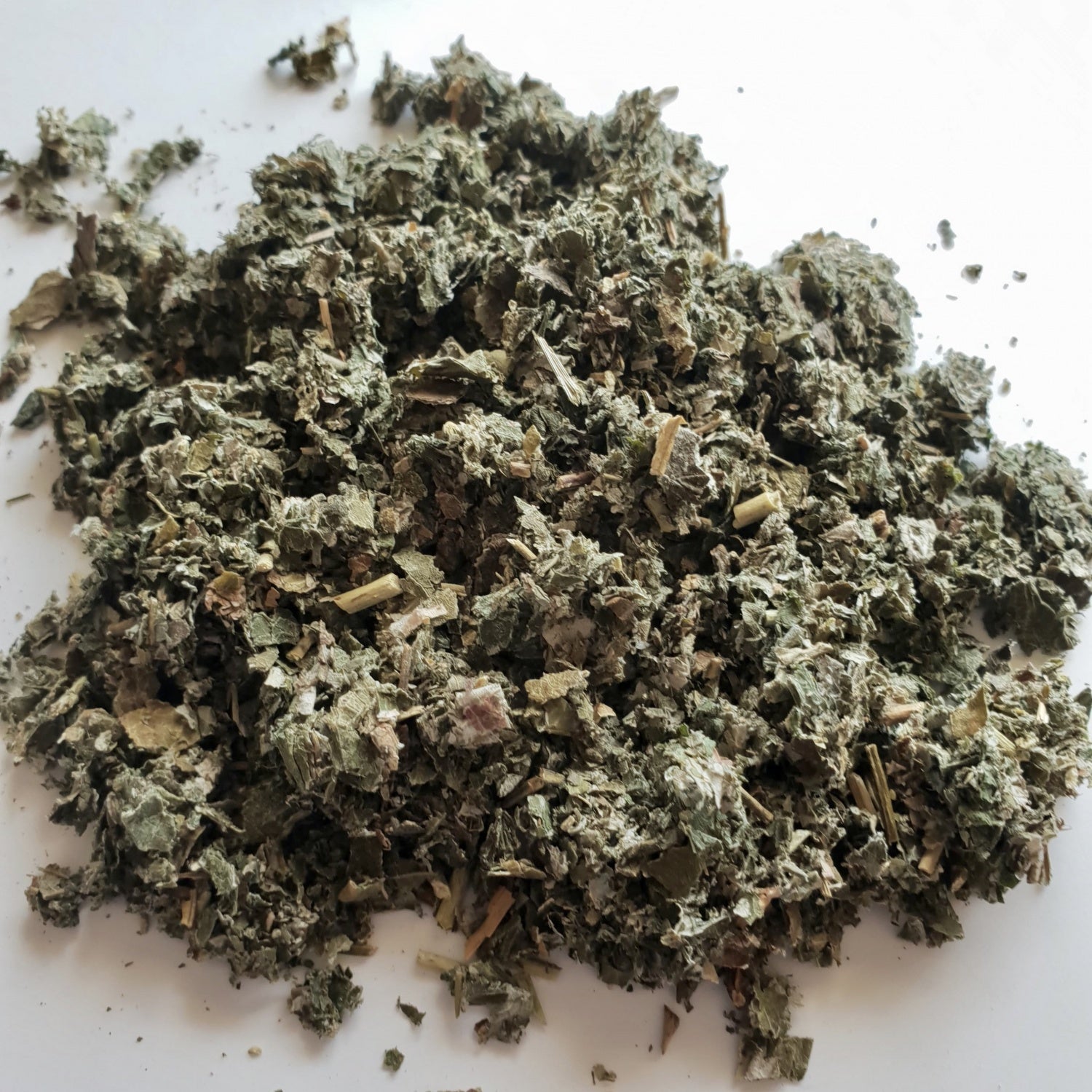 Raspberry Leaf herb on a white surface.