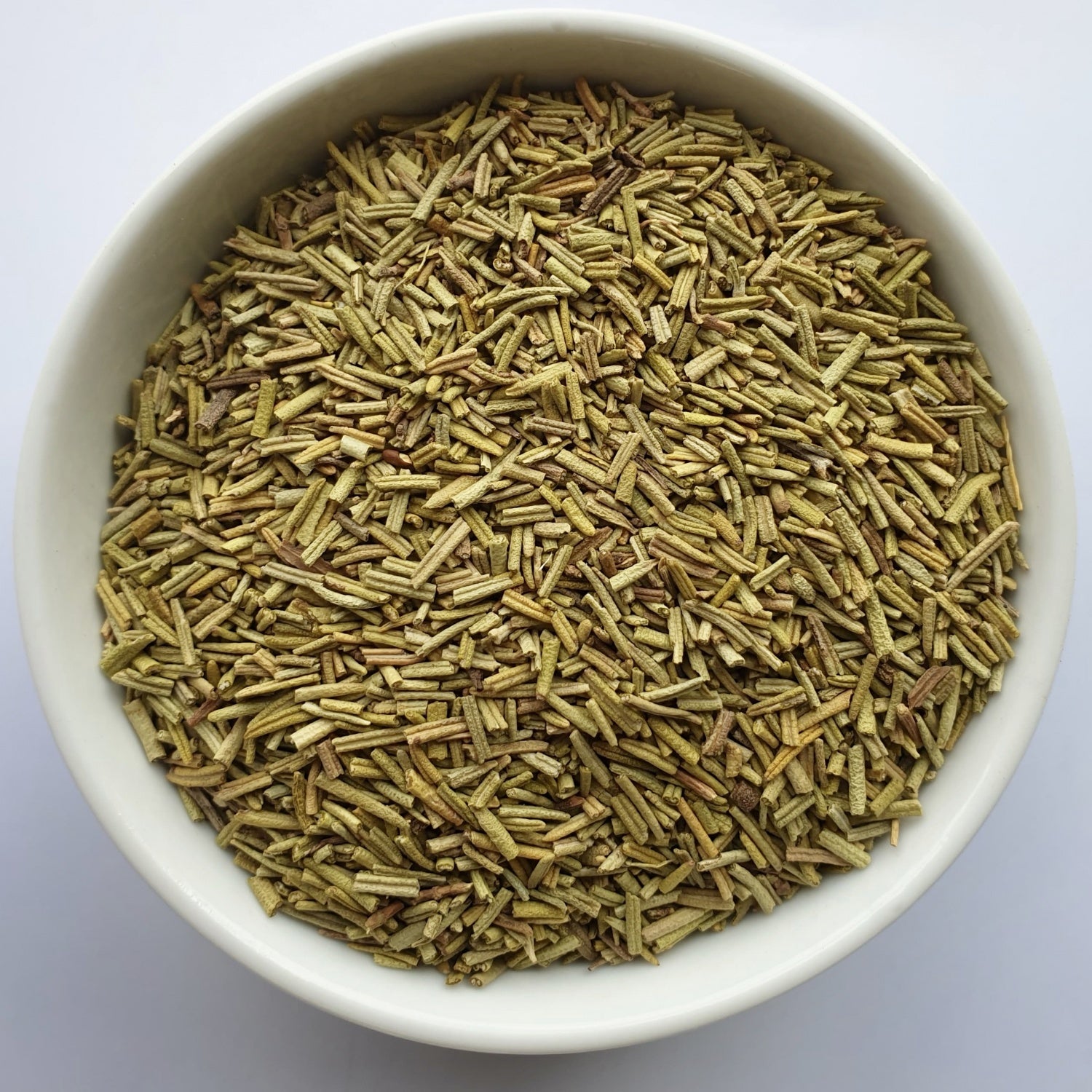 Rosemary herb on a white surface.