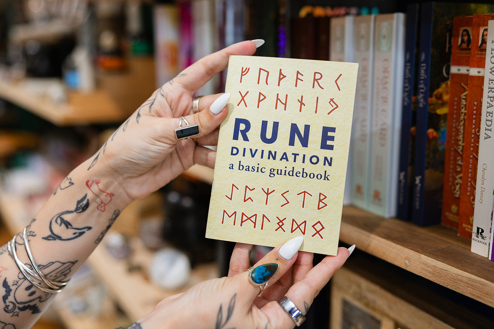 Book Rune - Divination Book in front of a shelf of books