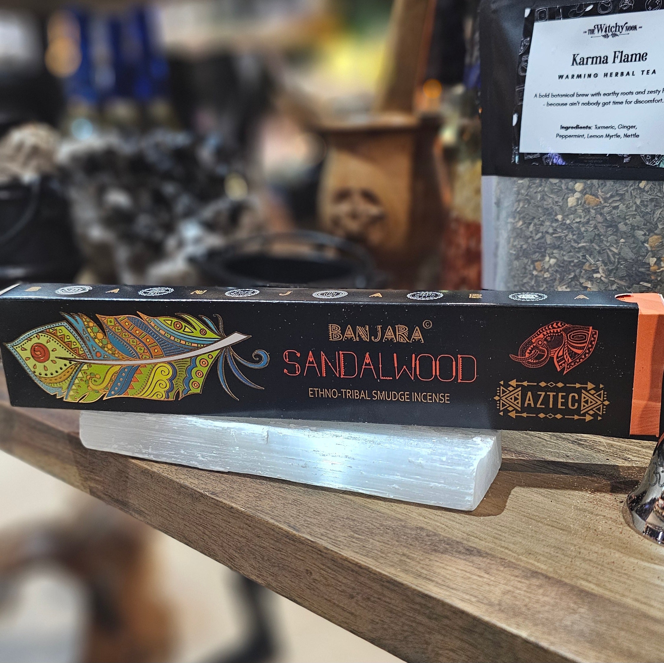 ‘Banjara Sandalwood Incense’ Displayed on a wooden table surrounded by crystals and herbs. 