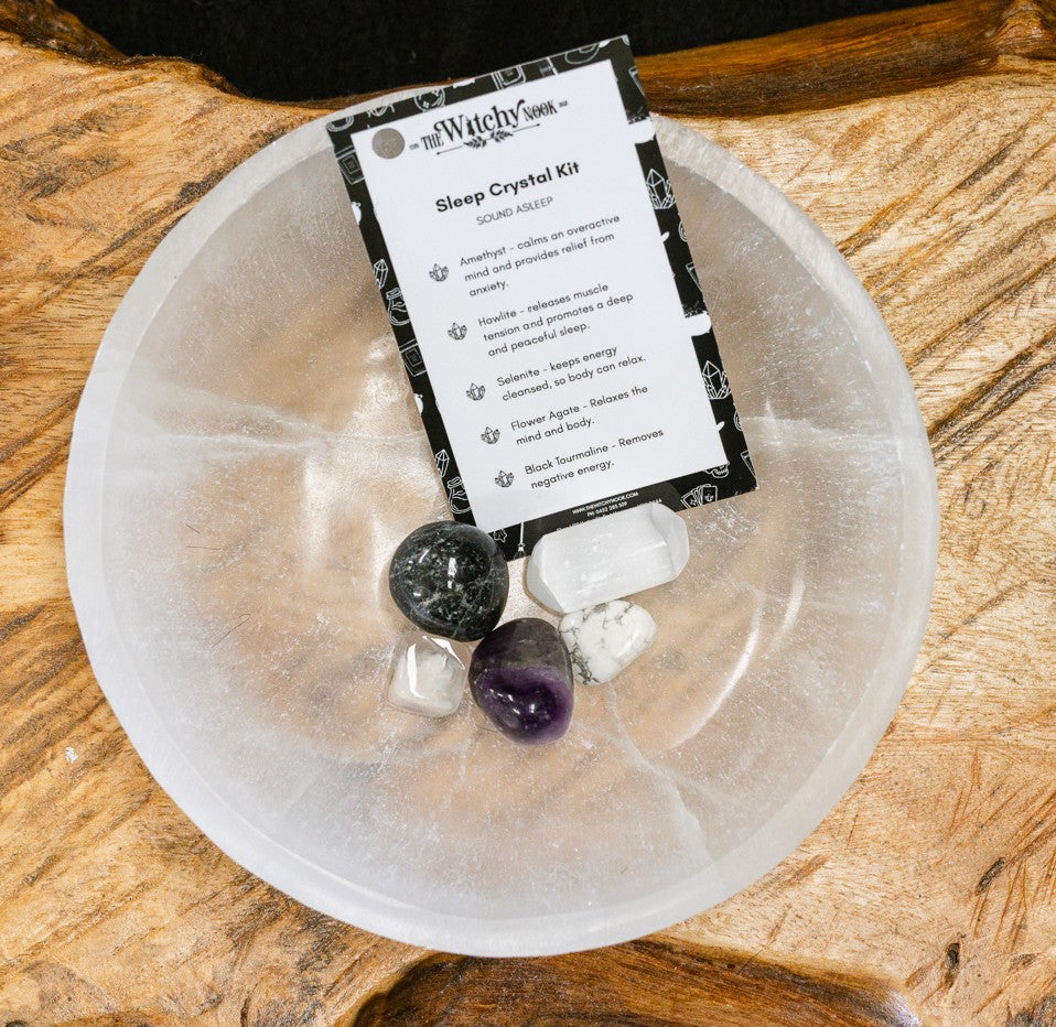 Packaged product labeled 'Sleep Crystal Kit' by 'Witchy Nook' on a wooden surface in the background with products displayed in a bowl.
