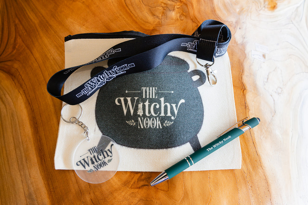 A collection of The Witchy Nook Merchandise displayed on wooden background