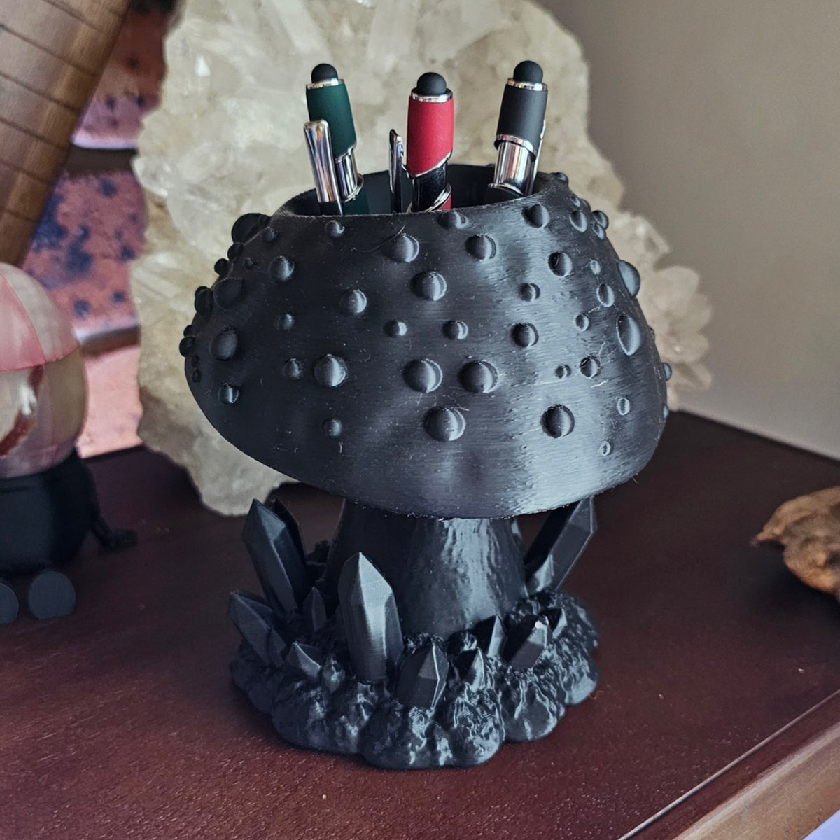 Goth mushroom brush holder & pen organizer cup. displayed on wooden surface with crystals in the background.