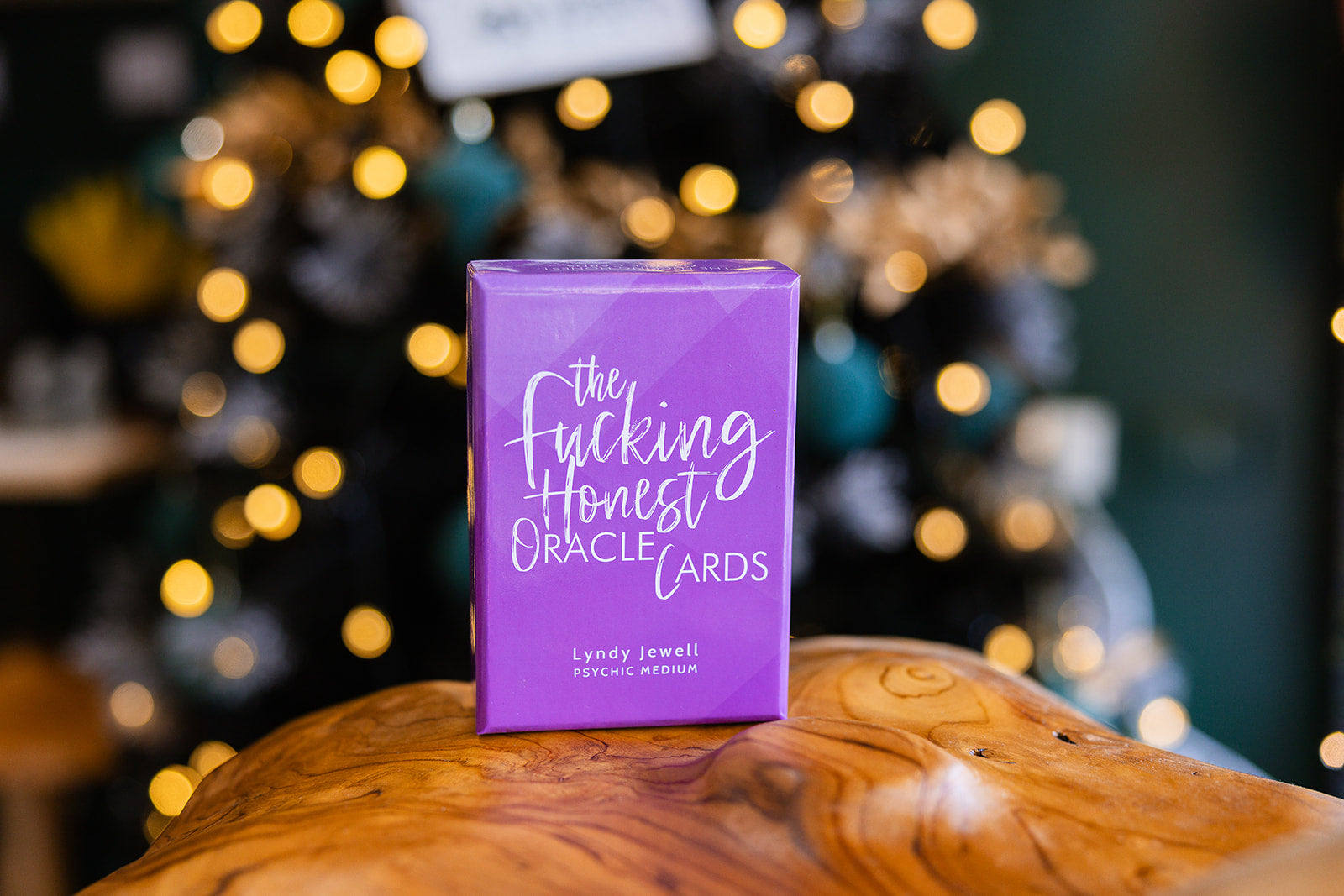 Tarot cards The F**king Honest Oracle Cards displayed on a wooden surface By Lyndy Jewell