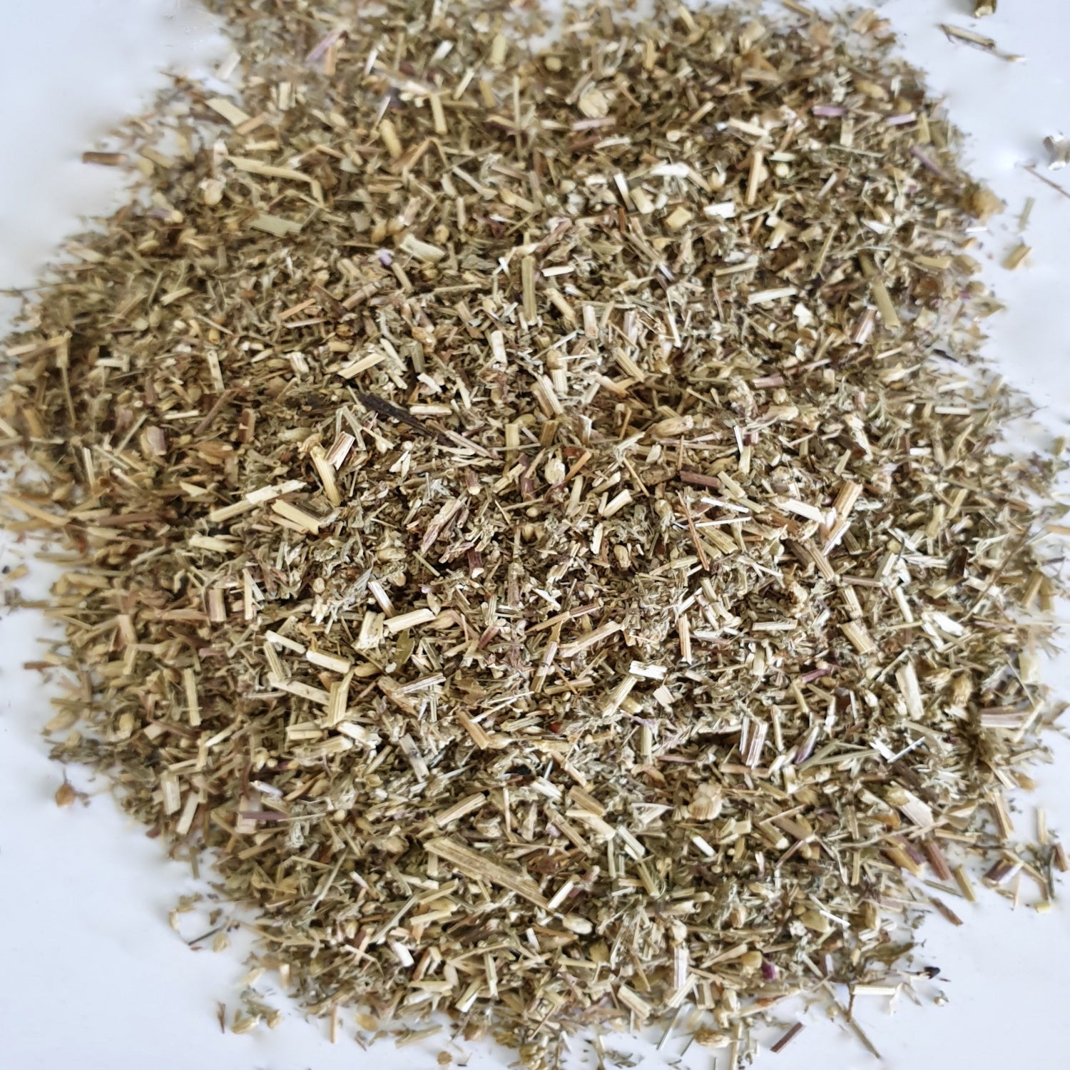 Yarrow herb displayed on a white surface.