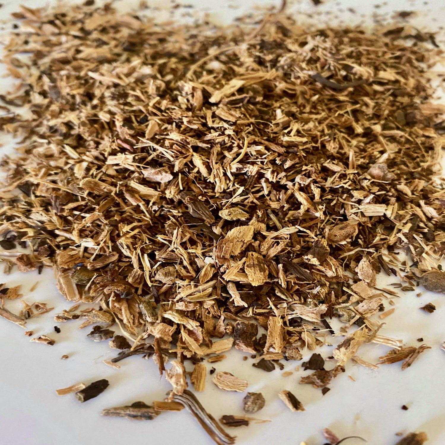 Yellow Doc Root herbs displayed on a white surface.