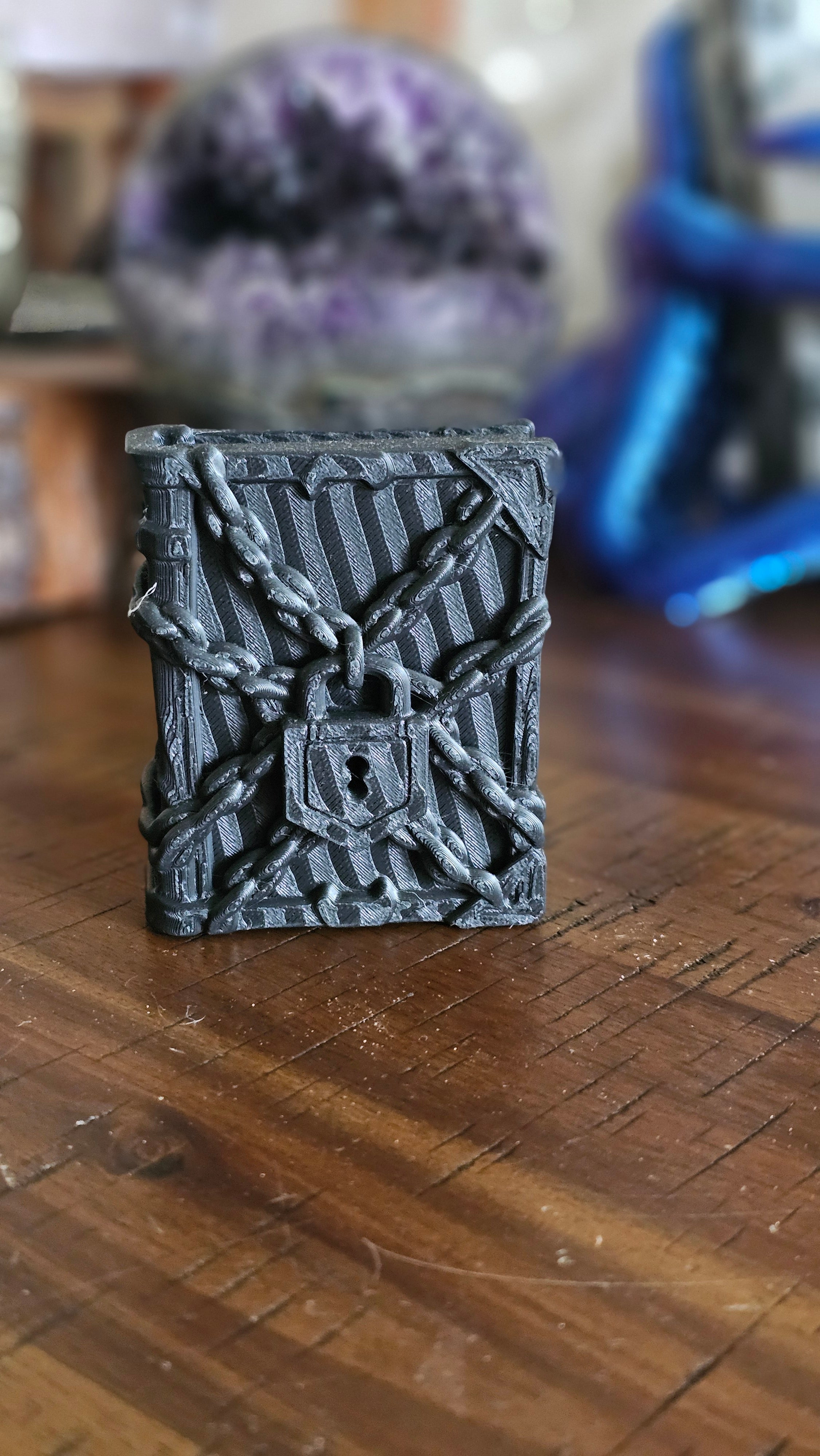 Forbidden spell book 3d PLA displayed on a wooden surface with crystals in the background. 