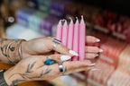 Person holding pink candles with a blurred background