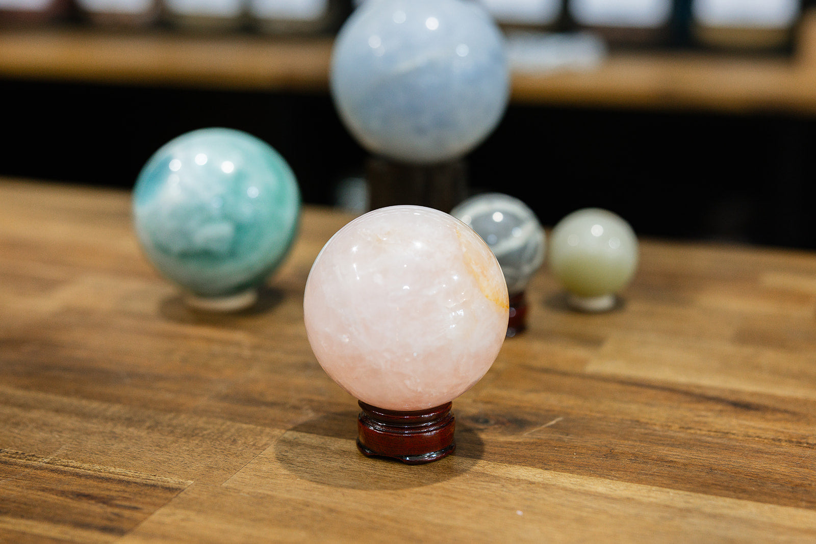 Set of colorful crystal balls on a wooden surface