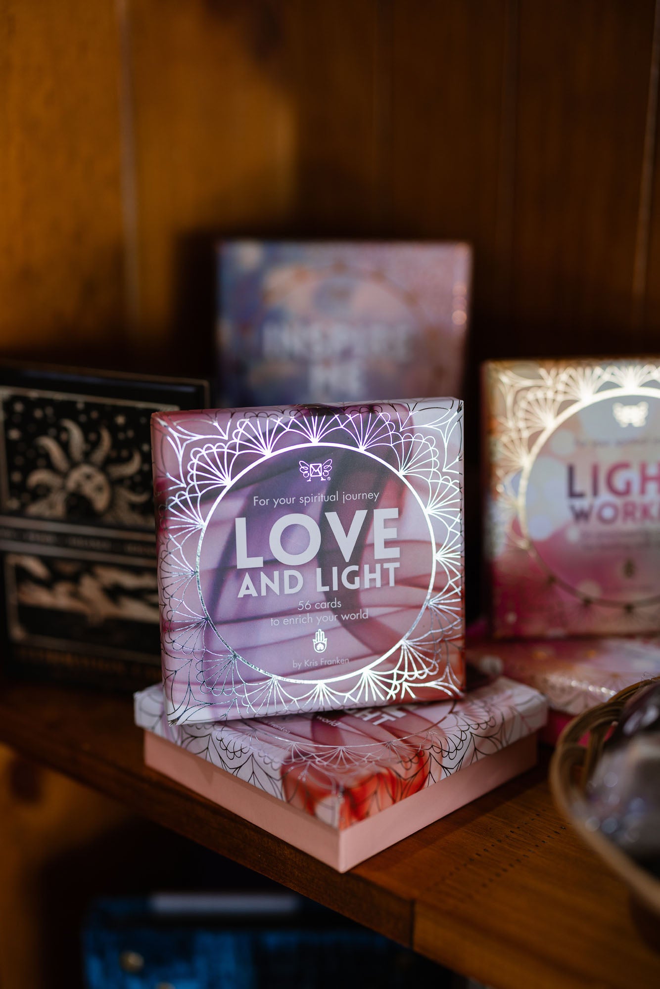 Box of cards with 'Love and Light' text on a wooden surface