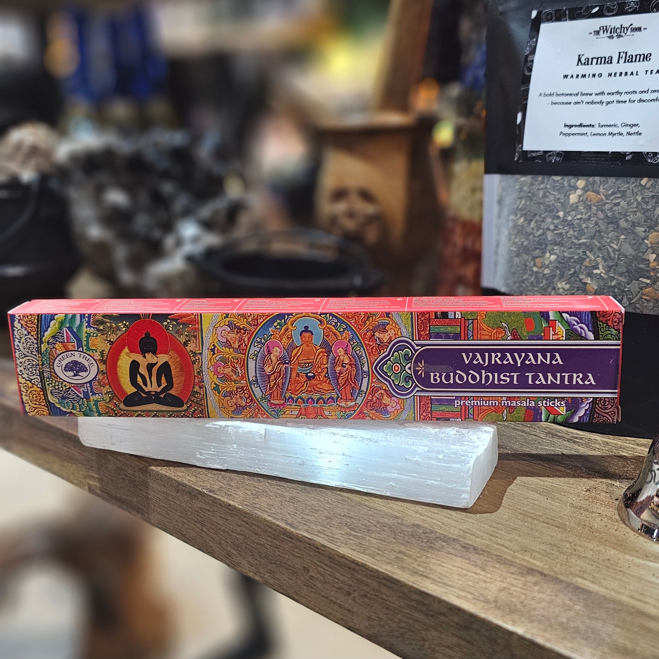 ‘Vajrayana Buddhist Tantra Incense’ Displayed on a wooden table surrounded by crystals and herbs. 